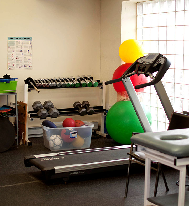 Photograph of the gym area of Victoria physiotherapy showing exercise balls and a treadmill.