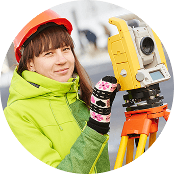 Woman in hard hat with surveying equipment